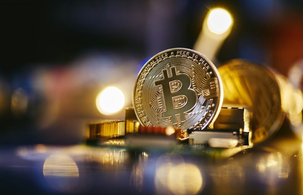 Close-up of a Bitcoin coin on a computer circuit board, symbolizing cryptocurrency and digital finance