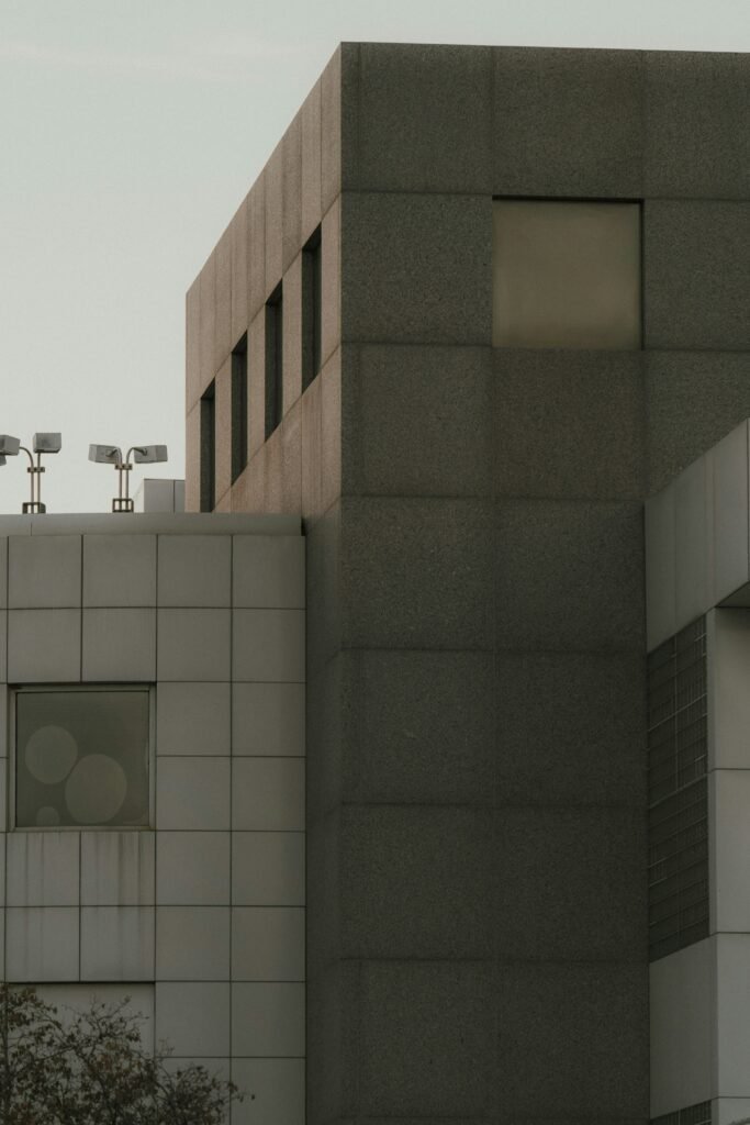 Concrete building exterior with windows and security cameras, symbolizing stability and surveillance in the crypto industry.