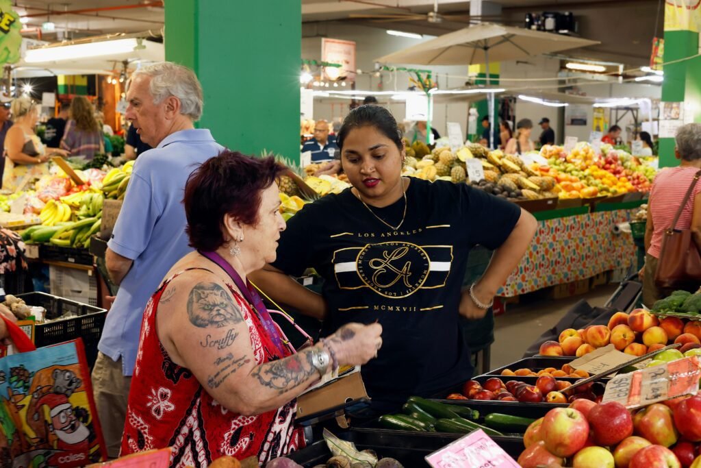 Market scene with diverse fruits and people interacting
