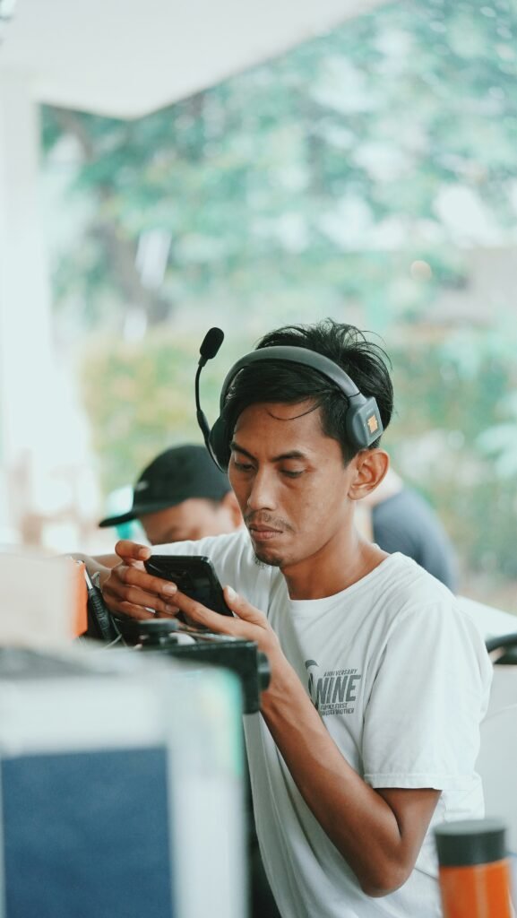 Person wearing a headset and using a smartphone, possibly browsing crypto news