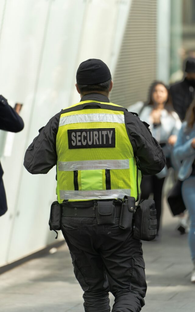 Security guard in bright vest ensuring safety at crowded event