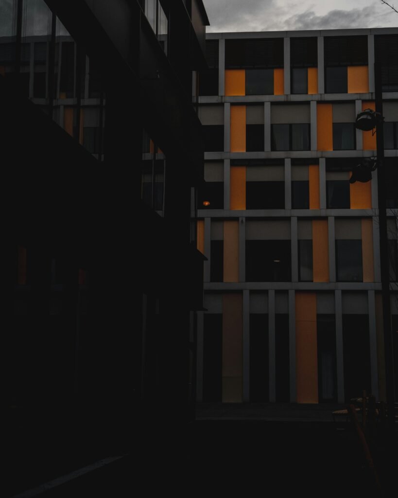 Modern office building with illuminated windows at dusk, representing technological advancements in crypto industry architecture.