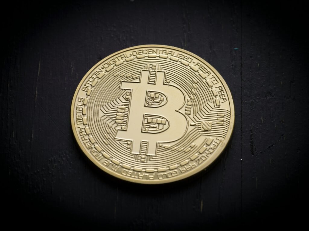Gold Bitcoin coin on a dark background
