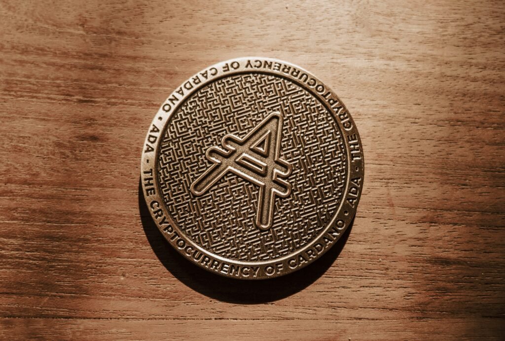 Close-up of a Cardano ADA cryptocurrency coin on a wooden surface