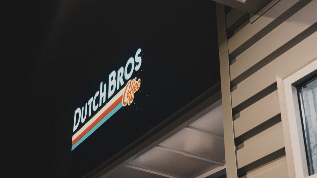 Illuminated Dutch Bros Coffee sign on building at night