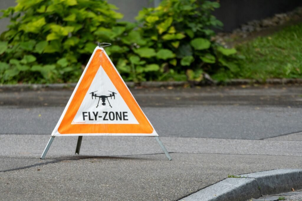 Fly-zone warning sign with drone symbol on pavement