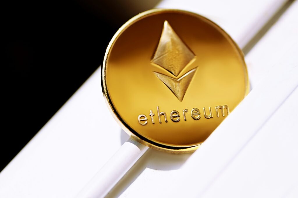 Close-up of a golden Ethereum coin with logo and text