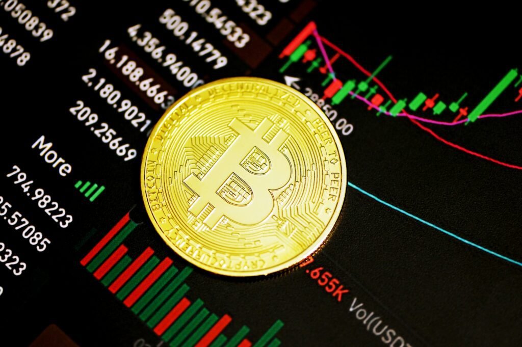 Bitcoin coin on a digital financial market chart