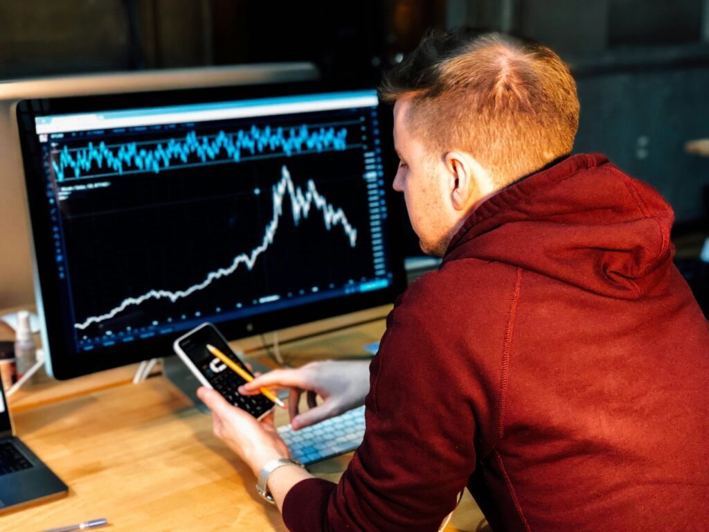 Person analyzing cryptocurrency market trends on a computer screen