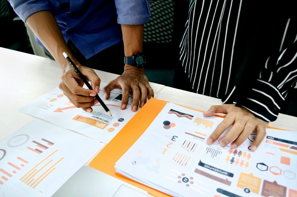 Two people reviewing cryptocurrency market analysis charts and graphs.