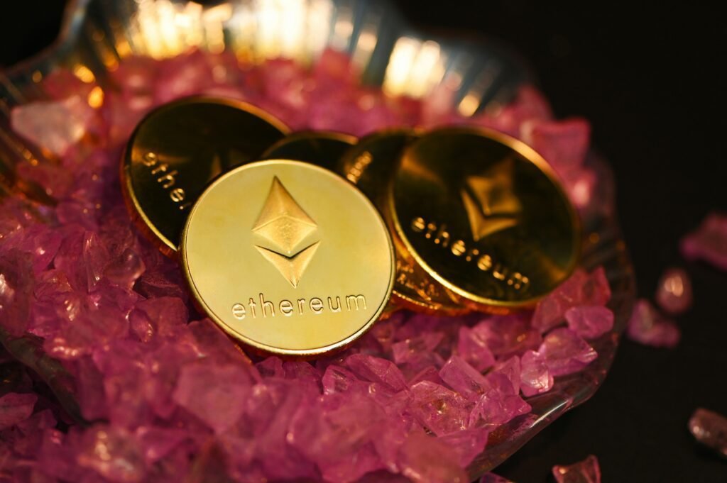 Golden Ethereum coins on a bed of purple crystals representing cryptocurrency