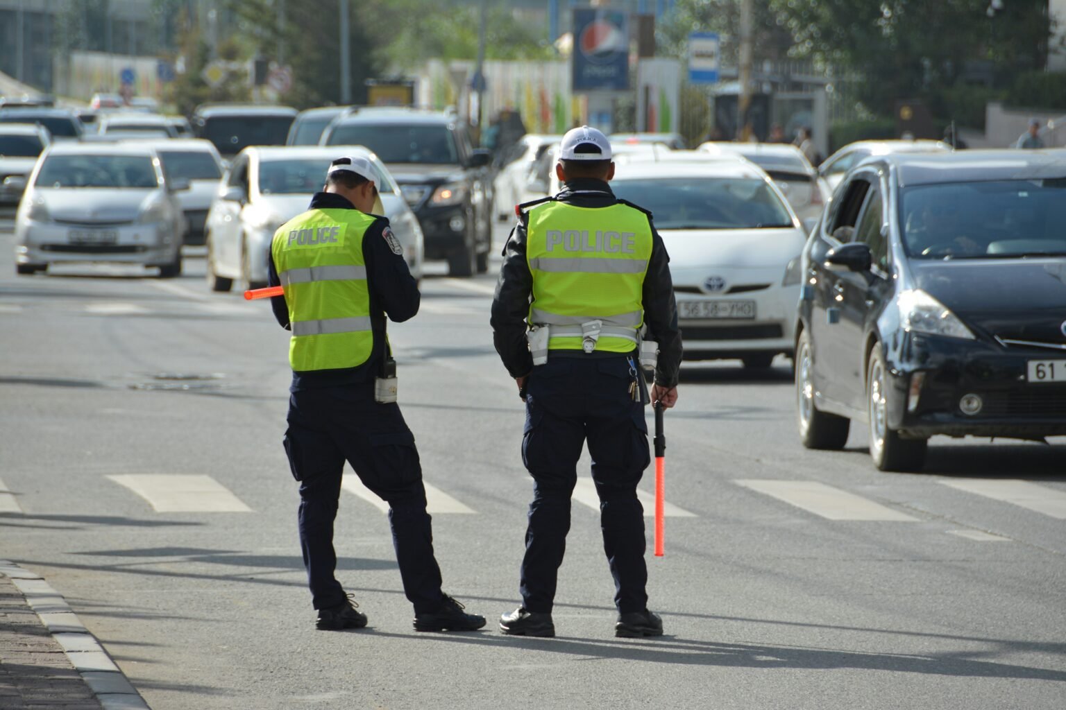 Two police officers managing city traffic on a busy street